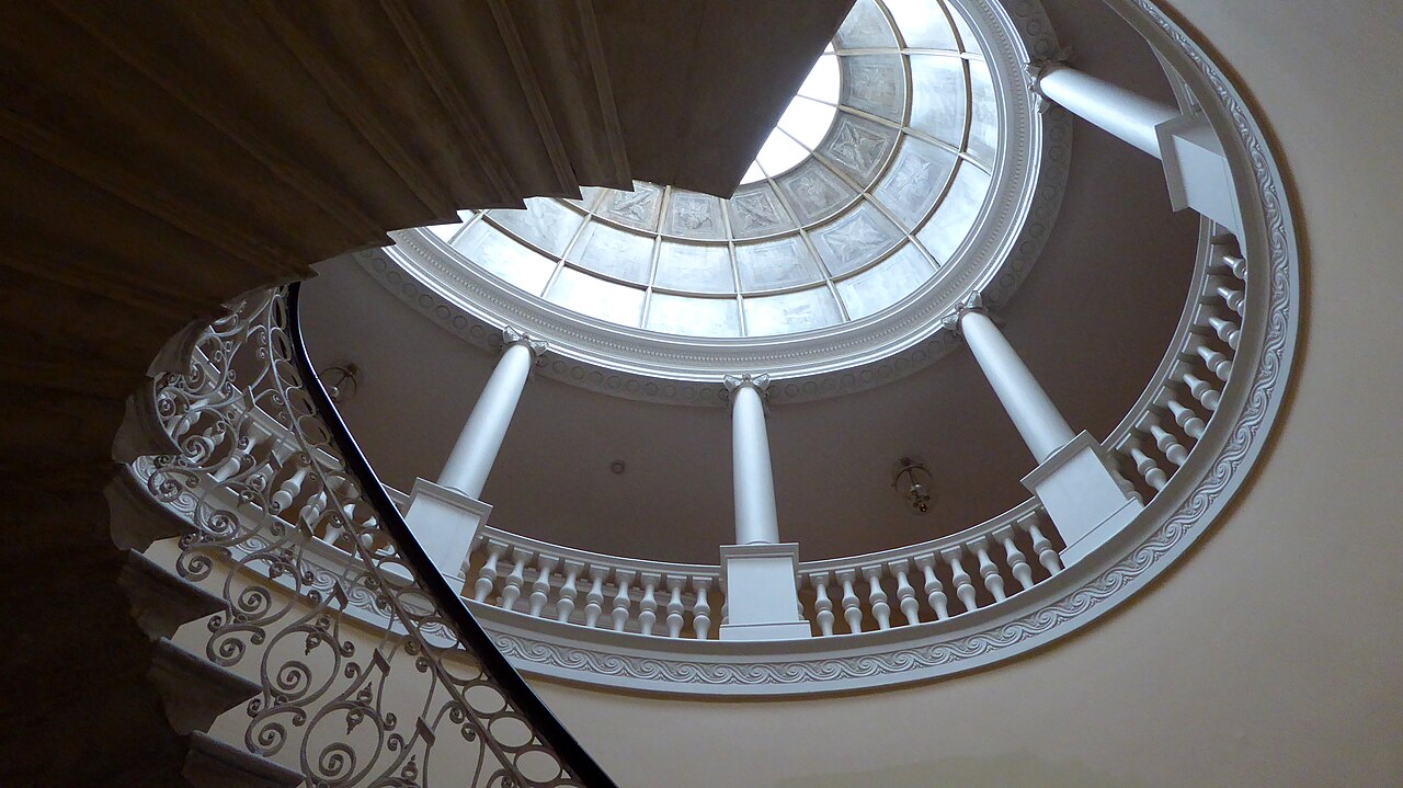 The central oval staircase inside Danson House, with classical columns and a domed space above